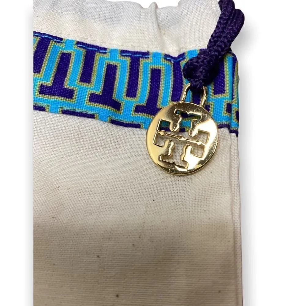 Tory Burch cream Dust bag with purple cord blue trim and gold signature hang tag